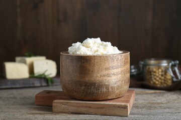 Delicious tofu cream cheese in bowl on wooden table