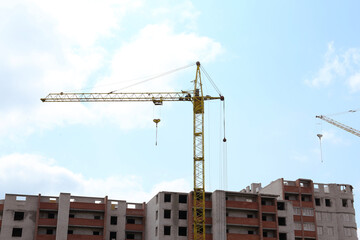 Fototapeta na wymiar Construction site with tower crane near unfinished building