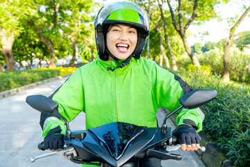 Asian woman works as a motorcycle taxi driver