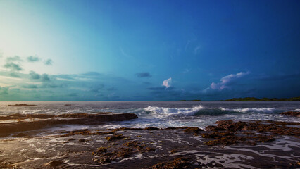 Sandy beach with the blue ocean