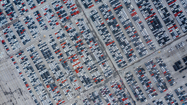 Aerial view car for sale stock lot row. Car dealer inventory, Car lined up at port import export business logistic dealership, Automobile and automotive car parking lot commercial business industry.