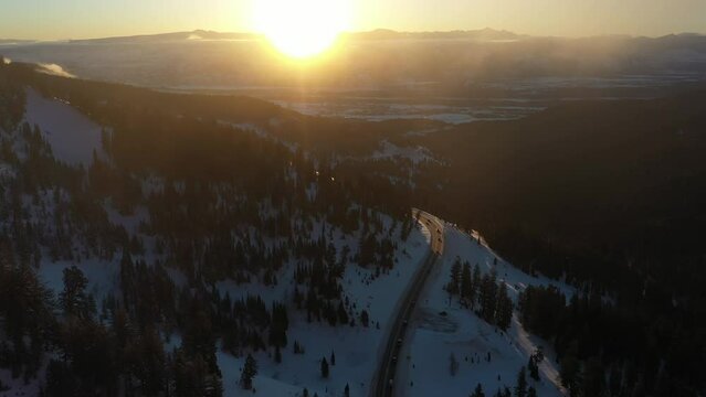 Aerial View of Winter Sunrise Above Rural Colorado, Snow, Forest and Empty Road. Hayden Pass USA
