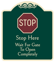 Decorative automatic gate warning sign and labels stop here wait for gate to open completely