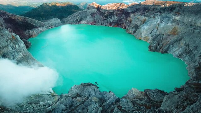 An active volcano with a baby blue lake in it, this is Mount Ijen in Indonesia. A flight over a place where miners still break down sulfur and carry it all the way up the crater with their bare hands.