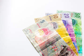 Group of money Maldives banknotes and coins on a white background. Maldives Currency rufiyaa note and coins, Maldivian rufiyaa money. Money and finances concept ,space for text.
