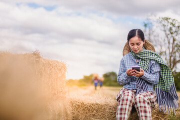 Naklejka na ściany i meble woman farmer using technology mobile in rice field 