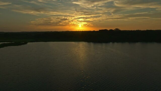  HQ Aerial footage - Drone moving up and camera moving down in sunset above the catazaja's lagoon
