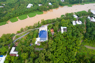 aerial view of Villa house in the middle of the garden with blue tile roof and the river at Mekong...
