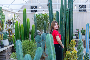 A woman standing in the garden planting cactus