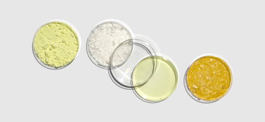 Sulfur Powder, Cetyl esters wax, Poly Aluminium chloride liquid and Carnauba Wax in Petri dish on...