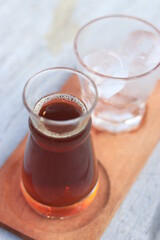 a glass of black coffe made using japanese technique and ice cubes in the morning