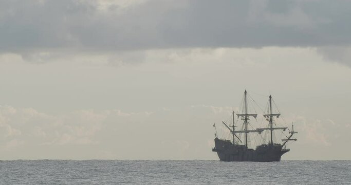 16th Century Galleon Andalucia replica ship sailing in the Mediterranean sea in a beautiful cloudy day at sunrise. 4K Slow motion 60fps exiting frame zoom shot.
