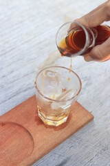 a glass of black coffe made using japanese technique and ice cubes in the morning