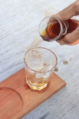 a glass of black coffe made using japanese technique and ice cubes in the morning