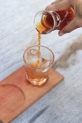 a glass of black coffe made using japanese technique and ice cubes in the morning