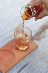 a glass of black coffe made using japanese technique and ice cubes in the morning