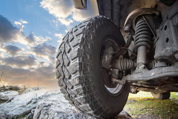 Car steering and suspension system of a offroader lifestyle. SUV overcomes natural obstacles in the...