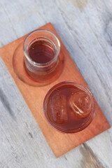 a glass of black coffe made using japanese technique and ice cubes in the morning