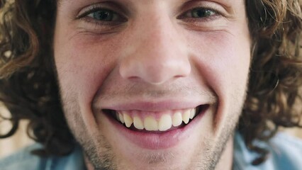 Face, smile and happy with a handsome man laughing or joking inside alone closeup with a positive attitude. Portrait, joy and carefree with a cheerful young male having a laugh with humor inside - Powered by Adobe