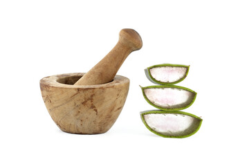 Aloe vera slices near mortar and pestle isolated on white