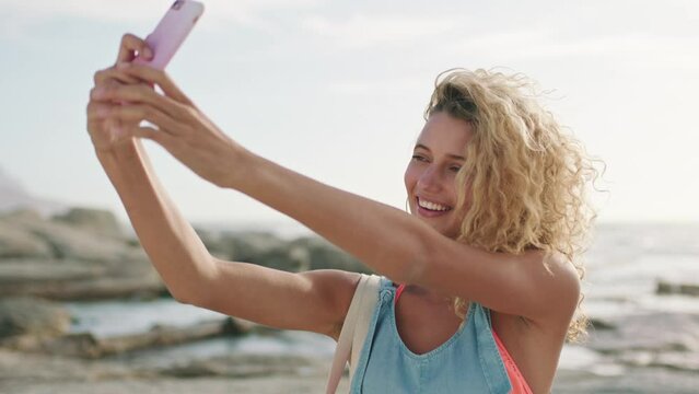 Selfie, smartphone and woman at the beach for social media post, networking on mobile app or location update in her travel blog. Young, happy gen z influencer girl in cellphone photography by the sea