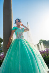 Fototapeta premium Beautiful young woman dressed in a princess costume in a landscape of pools of water and blue sky.