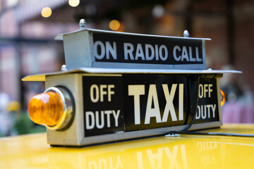 Close up of an old style yellow taxi cab top light.