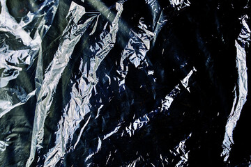 black cellophane bag close-up background texture of plastic