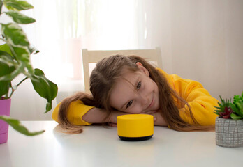girl talks to Alexa virtual assistant and gives her orders and commands what to turn on. The child...