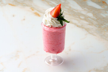 Mousse dessert with cream in glass on the table.