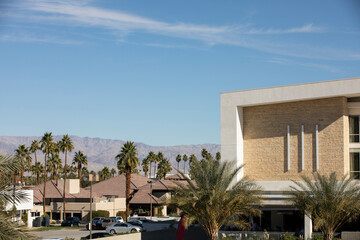 Fototapeta premium Palm tree framed view of downtown Palm Desert, California, USA.
