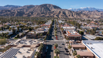 Daytime aerial view of the urban downtown area and mountains of Palm Desert, California, USA.