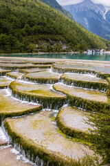 Fototapeta na wymiar Cascading pools in Blue Moon Valley with Jade Dragon Snow Mountain in the background in Lijiang, Yunnan, China