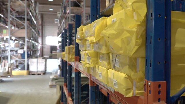 Large factory warehouse. Goods packed in yellow bags ready for shipment. logistics business freight mail. hd
