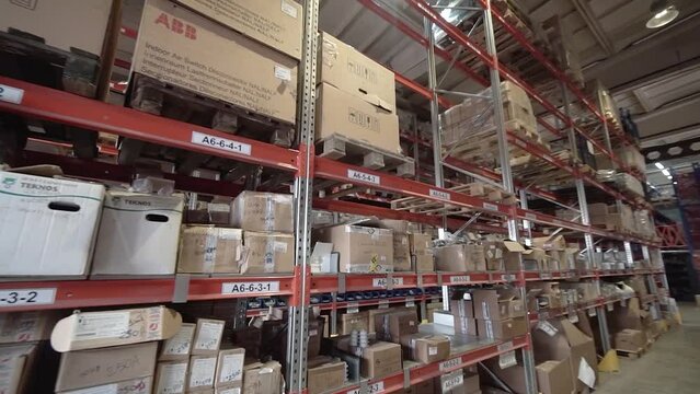 large factory warehouse. store aisles. The camera pans between shelves inside a large store. Delivery to the warehouse. Logistics business and forklift truck to move boxes and goods. freight mail