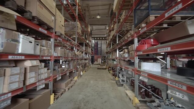 large factory warehouse. store aisles. The camera pans between shelves inside a large store. Delivery to the warehouse. Logistics business and forklift truck to move boxes and goods. freight mail