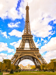 Eiffel Tower with blue sky and white clouds with park