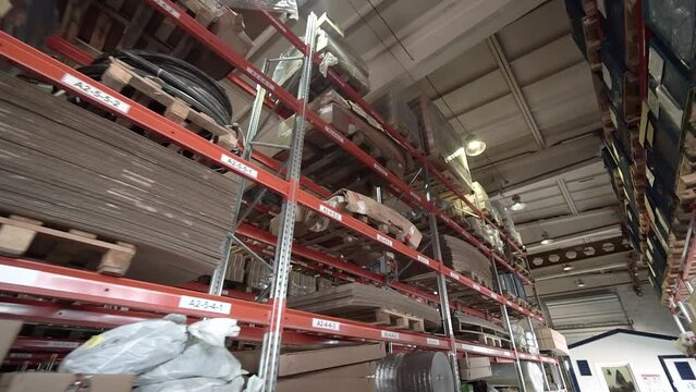 large factory warehouse. store aisles. The camera pans between shelves inside a large store. Delivery to the warehouse. Logistics business and forklift truck to move boxes and goods. freight mail