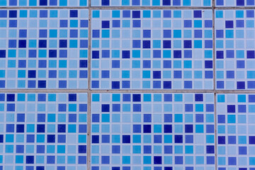 Ceramic tiles on bottom of pool in blue colors. Horizontal.