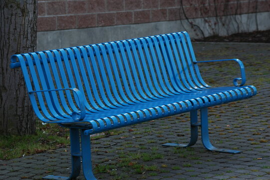 Blue park bench outdoors.