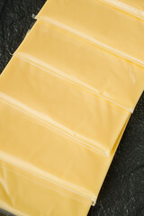 slices of American cheddar cheese on a white background