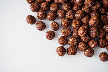 sweet crunchy chocolate children's breakfast chocolate balls on a white background