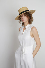 Series of studio photos of young female model in white midi dress	