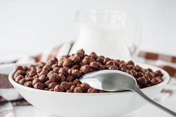 sweet crunchy chocolate children's breakfast chocolate balls on a white background