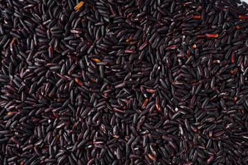 raw fresh black rice on a white background