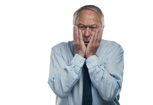 PNG shot of a senior businessman standing against a grey studio background with his face in his hands and looking concerned