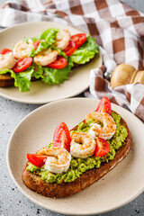 delicious Italian bruschetta with shrimps on a gray stone background