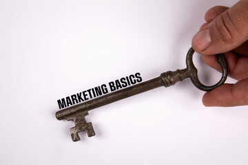 Marketing Basics concept. Knowledge and learning. Old key on a white background