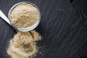 asafoetida aromatic powder on a black stone background
