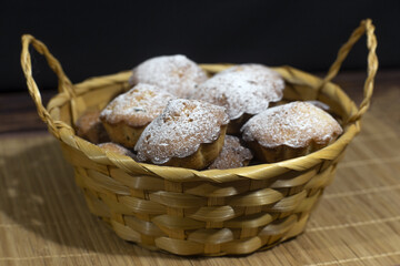 Homemade cupcakes sprinkled with powdered sugar. Muffins - delicious pastries. Delicious dessert on the table - homemade muffins. Portioned cupcakes. Simple muffin.